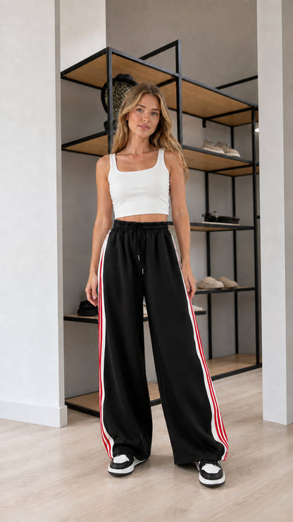 Front view of model wearing Black wide leg striped sweatpants