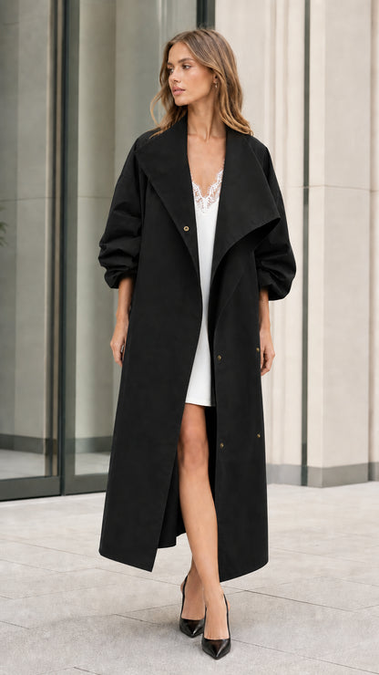 Model wearing longline black oversized duster trench coat with heels