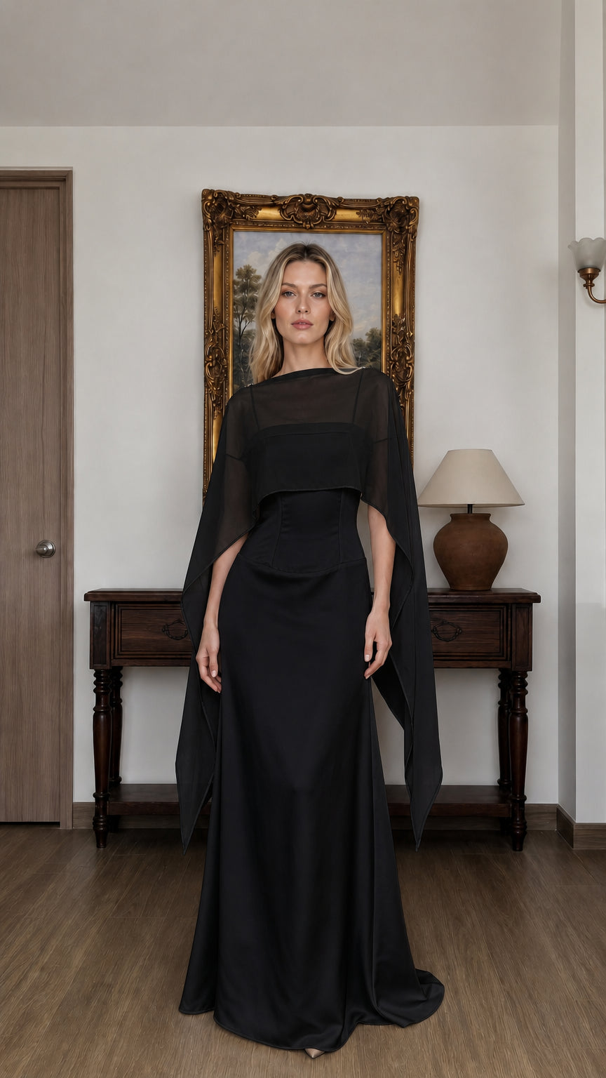 Front view of woman wearing black cape overlay evening dress