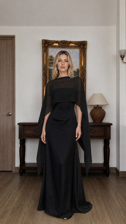 Front view of woman wearing black cape overlay evening dress