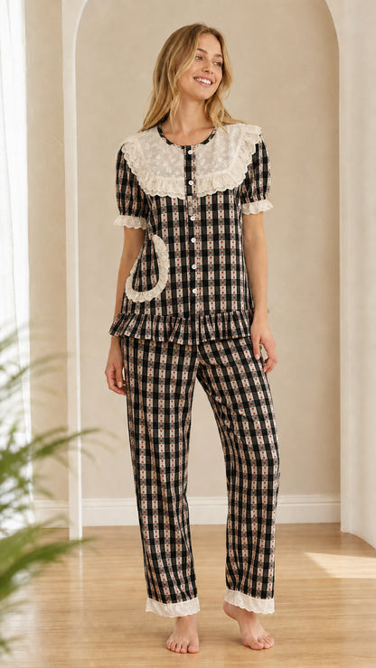 Model wearing black and white gingham pajama set with white lace collar