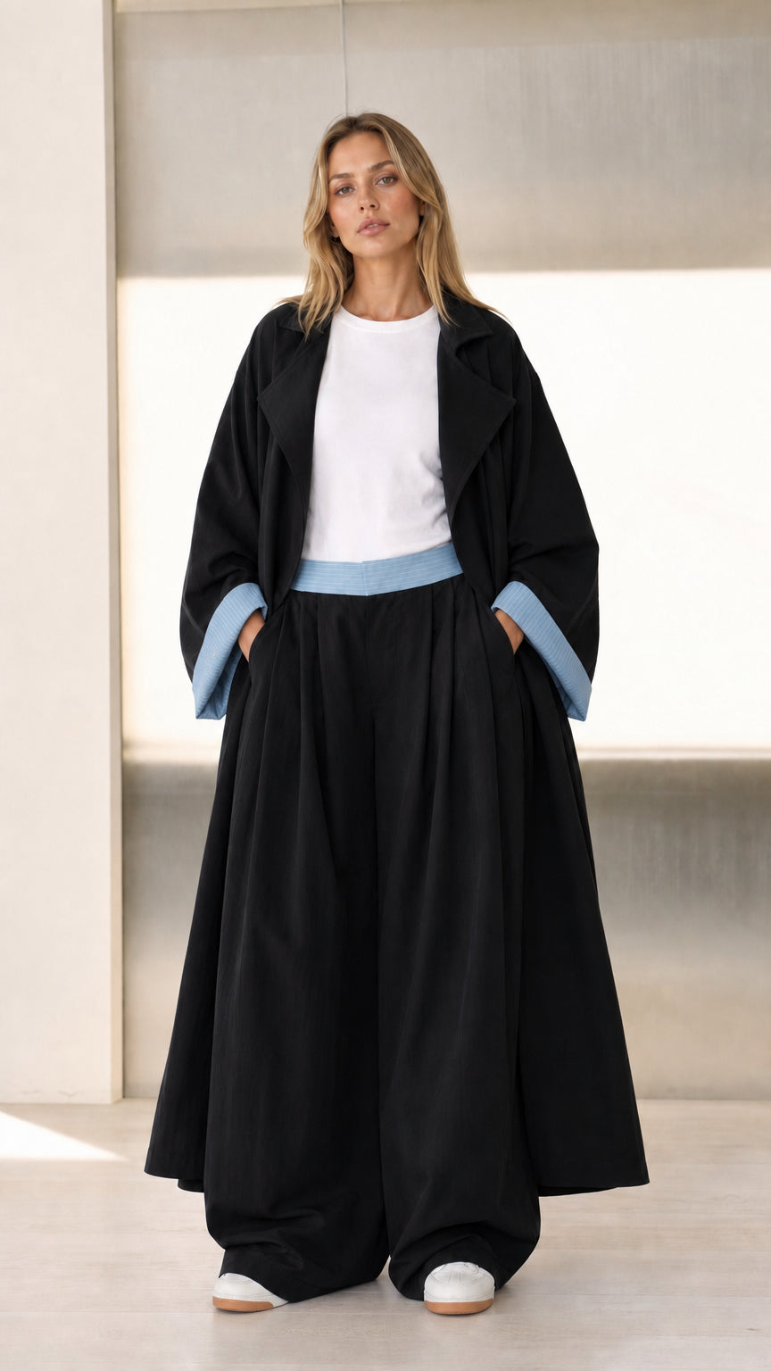Front view of Black duster coat and wide-leg pants set with contrast trim