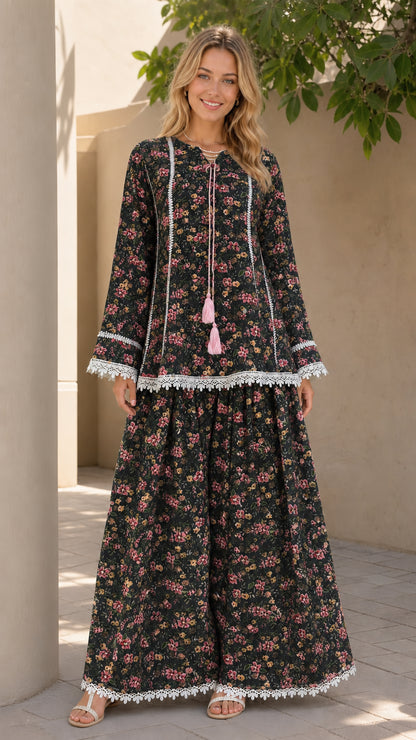 Model wearing black floral matching tunic and pants set