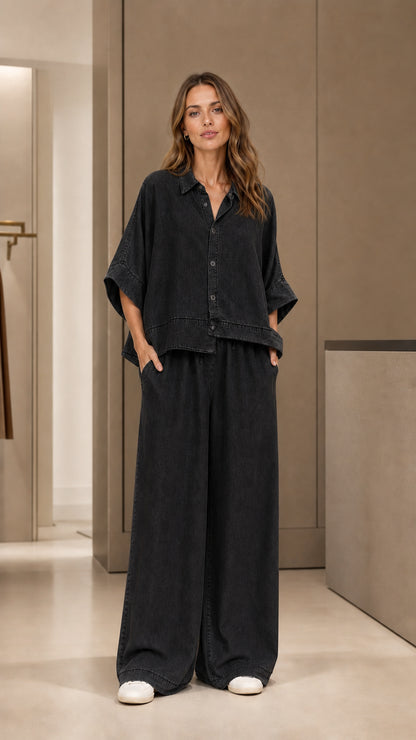 Full front view of model wearing black two-piece pants set