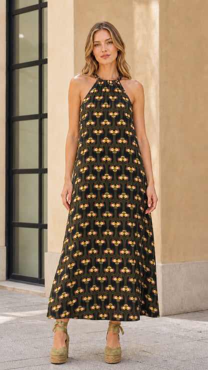 Model wearing black geo print halter maxi dress