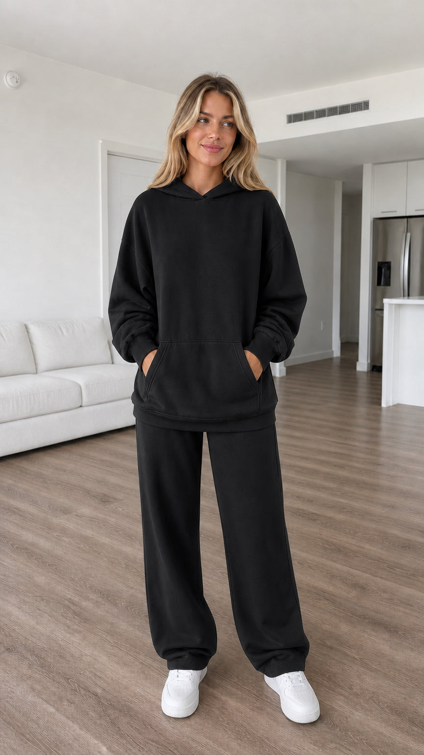 Model wearing black oversized hoodie and wide-leg sweatpants set
