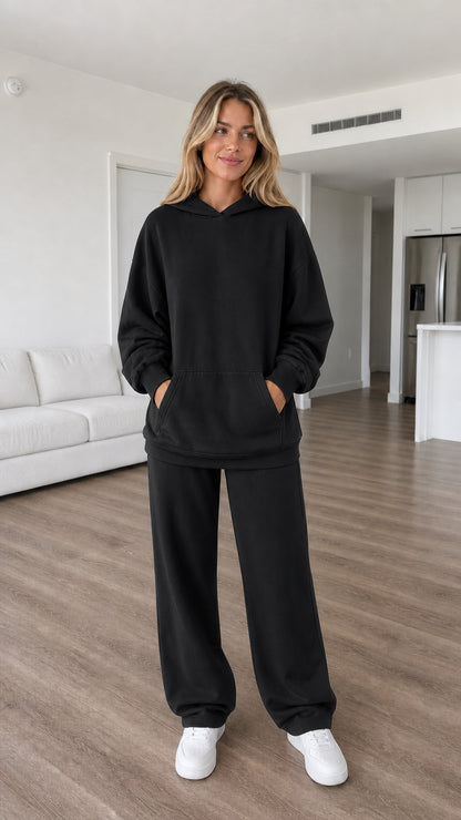 Model wearing black oversized hoodie and wide-leg sweatpants set