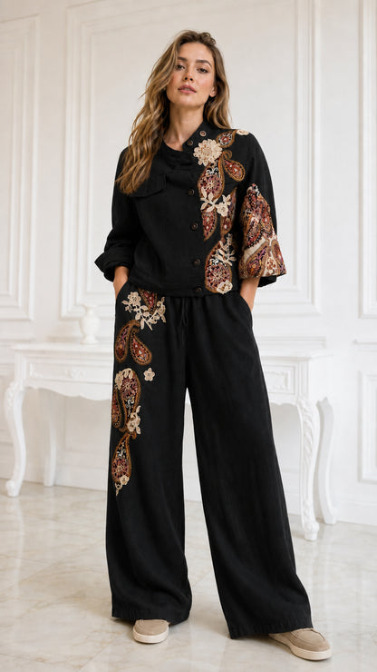 Model wearing black embroidered beaded jacket and matching wide-leg pants set