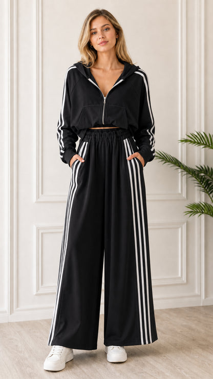 Full-length front view of woman wearing Black 2-piece striped hoodie and wide leg sweatpants set