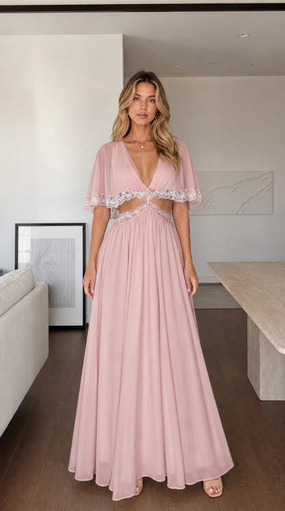 Front view of woman wearing pink maxi dress with lace cut-outs