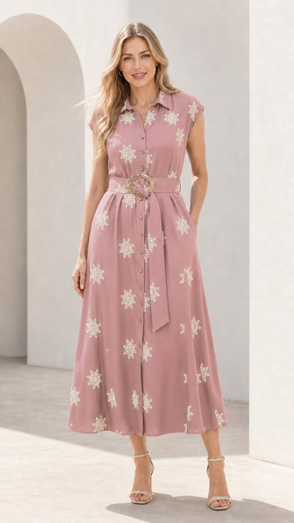 Front view of woman wearing dusty pink embroidered midi shirt dress