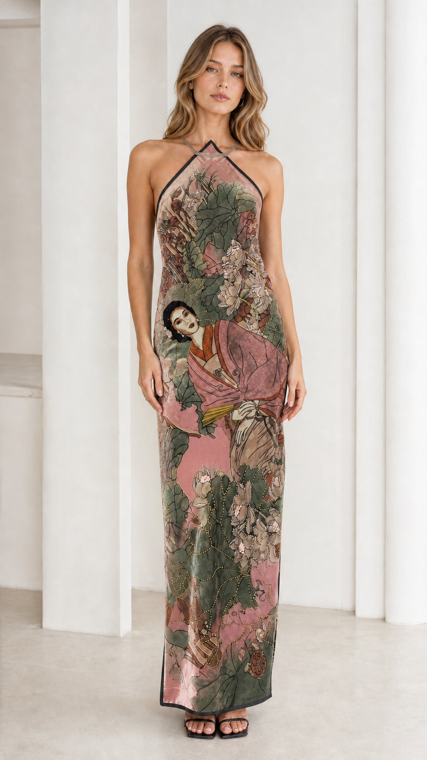 Model wearing pink velvet halter maxi dress