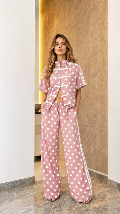 Model wearing pink polka dot track set
