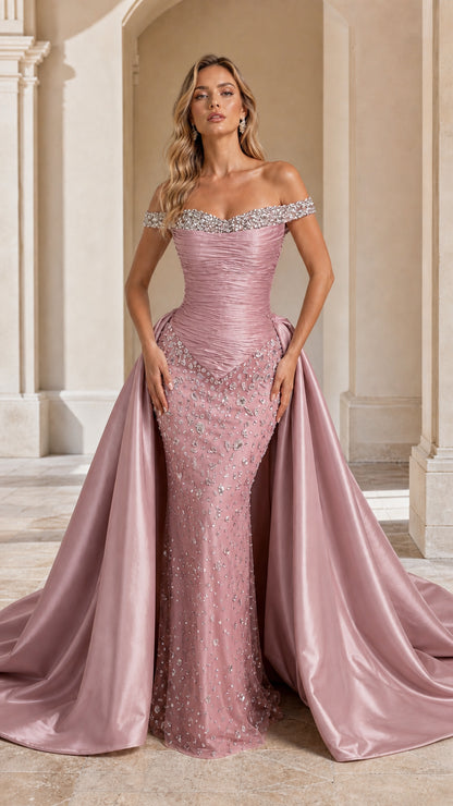 Model wearing Dusty Rose off-the-shoulder crystal-embellished evening gown with overskirt