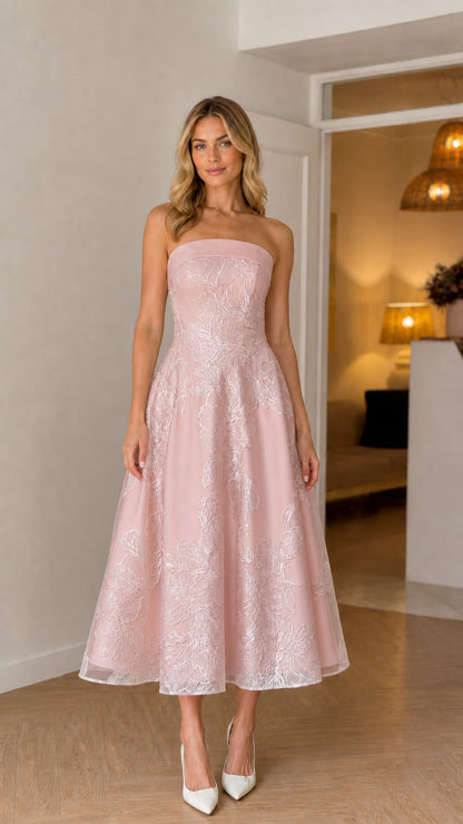 Model wearing soft pink strapless floral embroidered midi dress