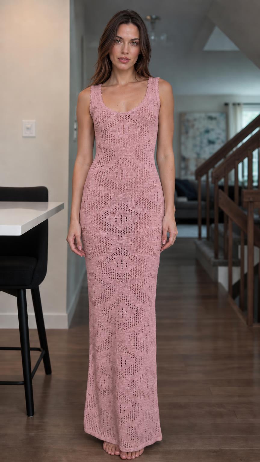 Front view of woman wearing pink open knit maxi dress