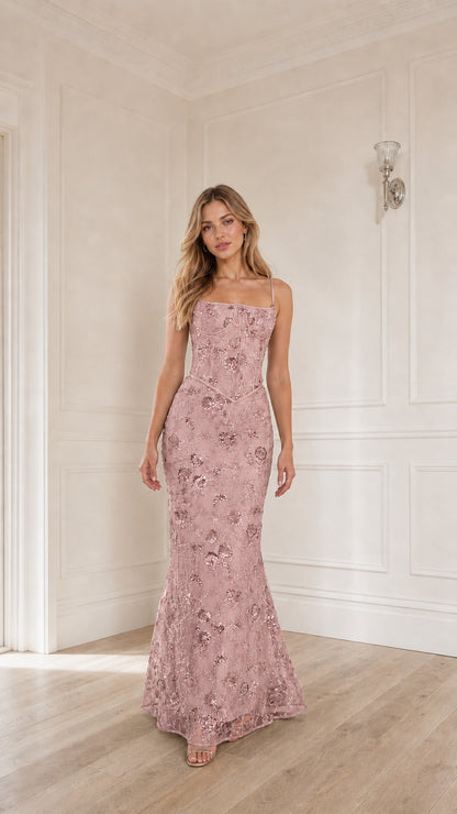 Woman wearing pink sequin embroidered corset maxi dress