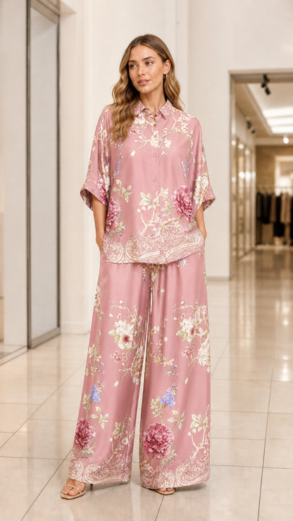 Model wearing dusty pink floral print satin two-piece shirt and pants set