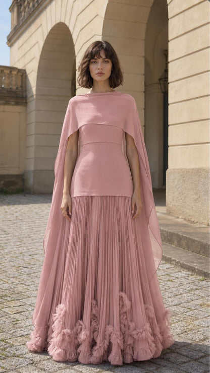 Front view of woman wearing pink cape overlay pleated maxi dress