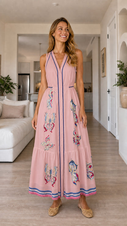 Woman wearing pink butterfly print maxi dress