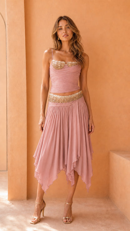 Model wearing pink embellished corset top and skirt set