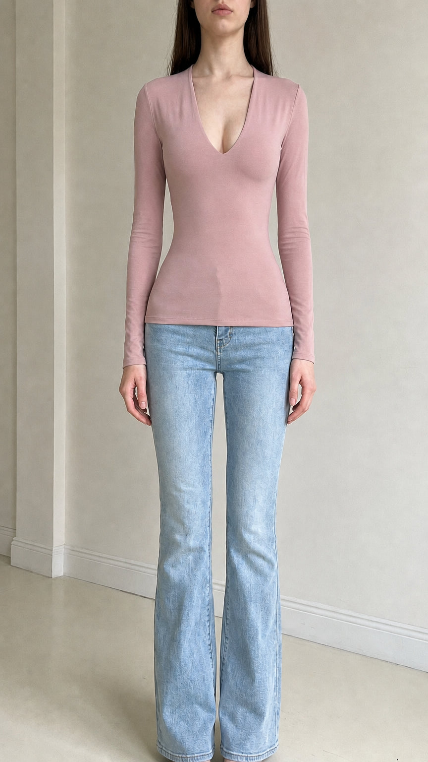 Front view of woman wearing pink deep v-neck long sleeve top