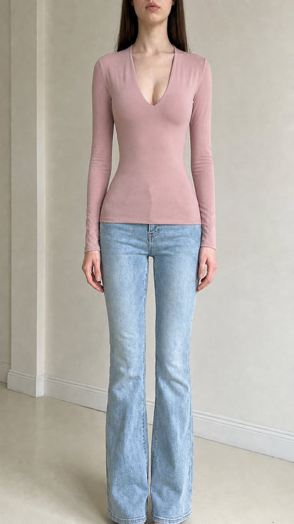 Front view of woman wearing pink deep v-neck long sleeve top