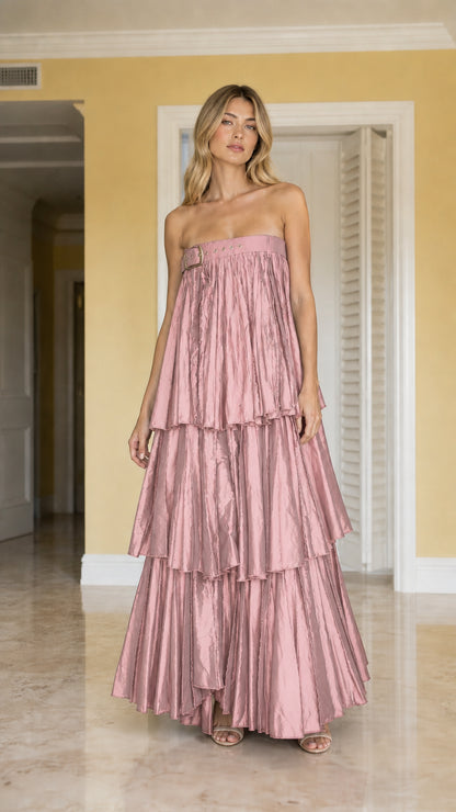 Front view of model wearing dusty pink strapless tiered pleated maxi dress