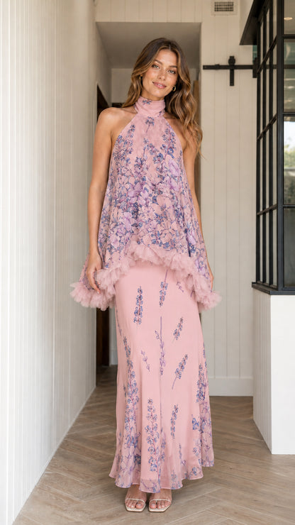 Model wearing dusty pink floral halter maxi dress with ruffle overlay