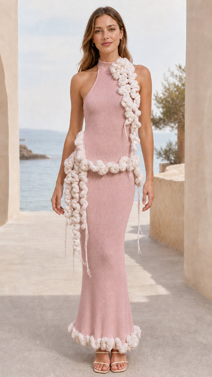 Full-length view of dusty pink halter neck ribbed knit maxi dress with cream pom pom trim