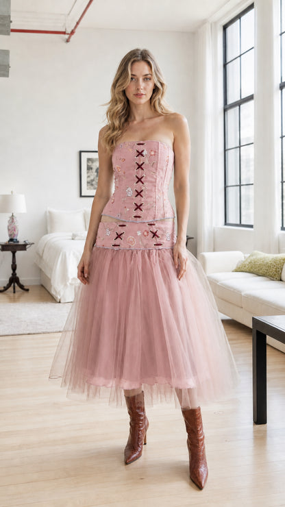 Model wearing dusty pink embroidered corset and tulle skirt set