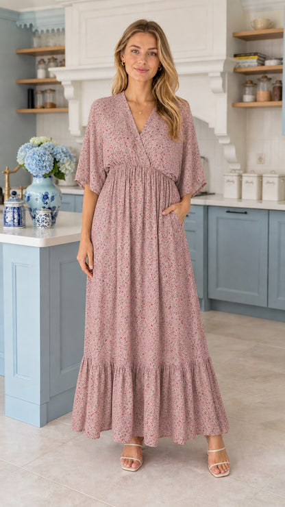 Front view of model wearing dusty mauve floral tiered maxi dress with pockets