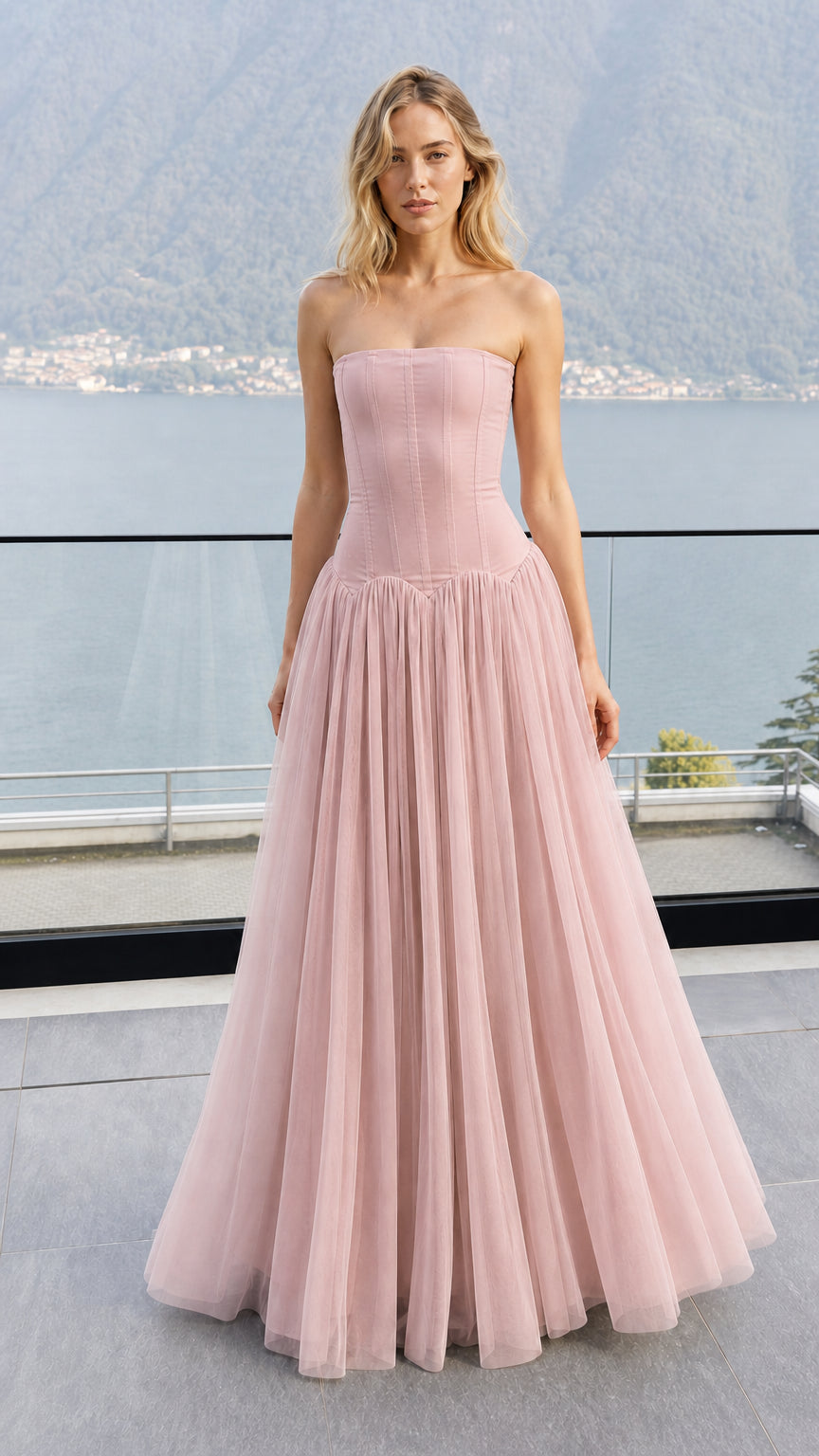 Front view of model wearing dusty rose strapless corset tulle maxi dress