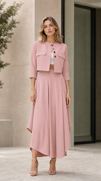 Model wearing dusty pink cropped jacket and asymmetrical maxi skirt set