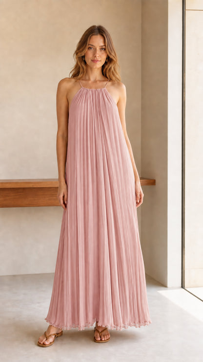 Model wearing blush pink pleated halter maxi dress