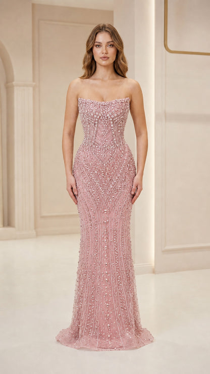 Front view of woman wearing pink strapless beaded evening gown