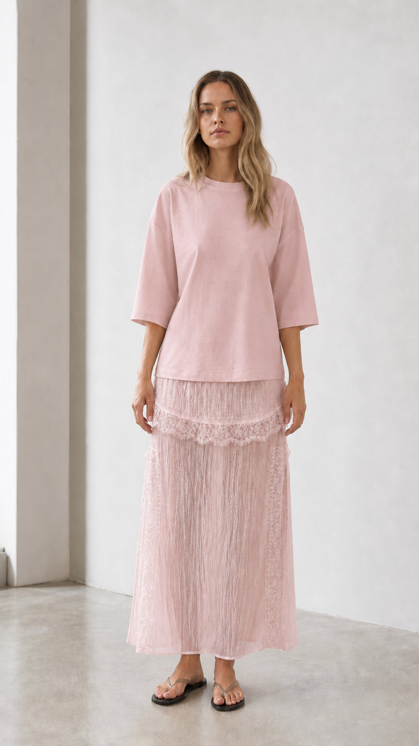Front view of woman wearing pink relaxed tee and matching skirt set