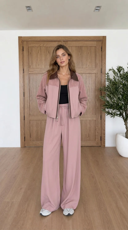 Model wearing dusty pink two-piece jacket and wide leg pants set