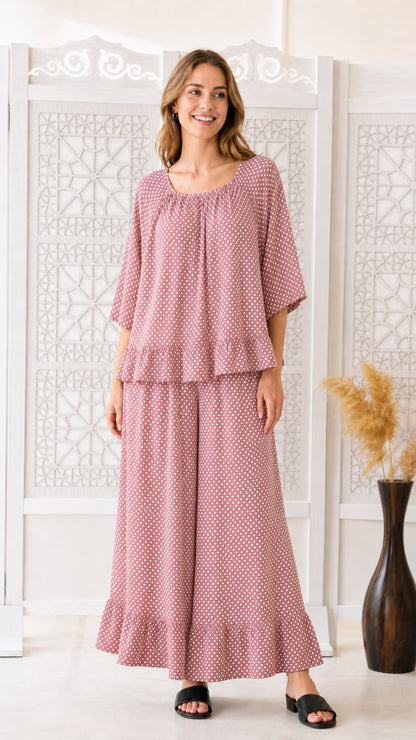 Front view of woman wearing dusty pink polka dot two-piece matching set