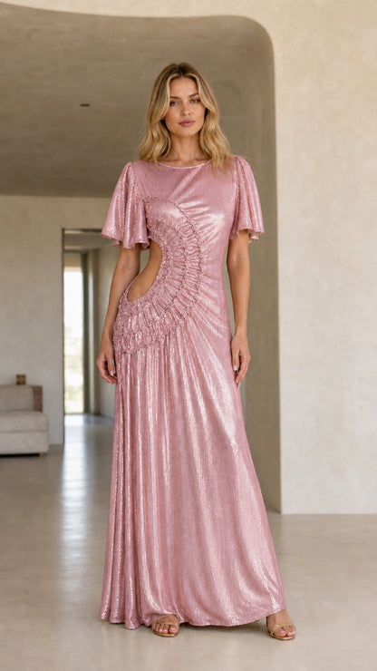Front view of woman wearing the pink color variant of the metallic cutout maxi dress