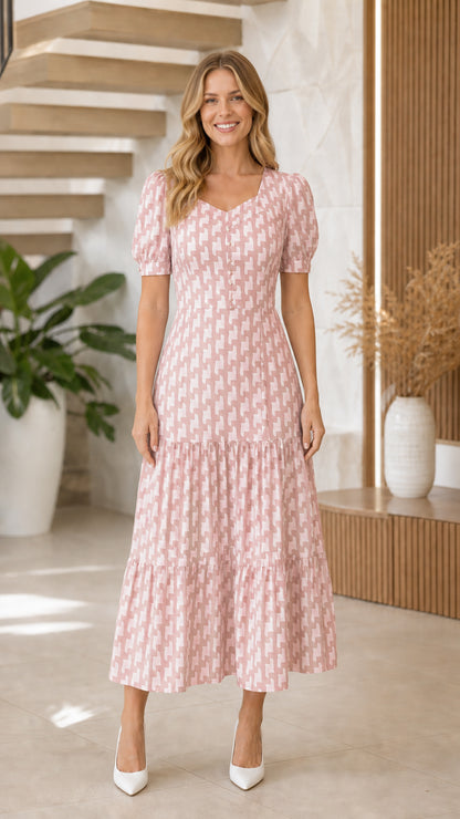 Model wearing pink geometric print maxi dress