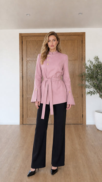 Model wearing blush pink belted tunic jacket with stand collar
