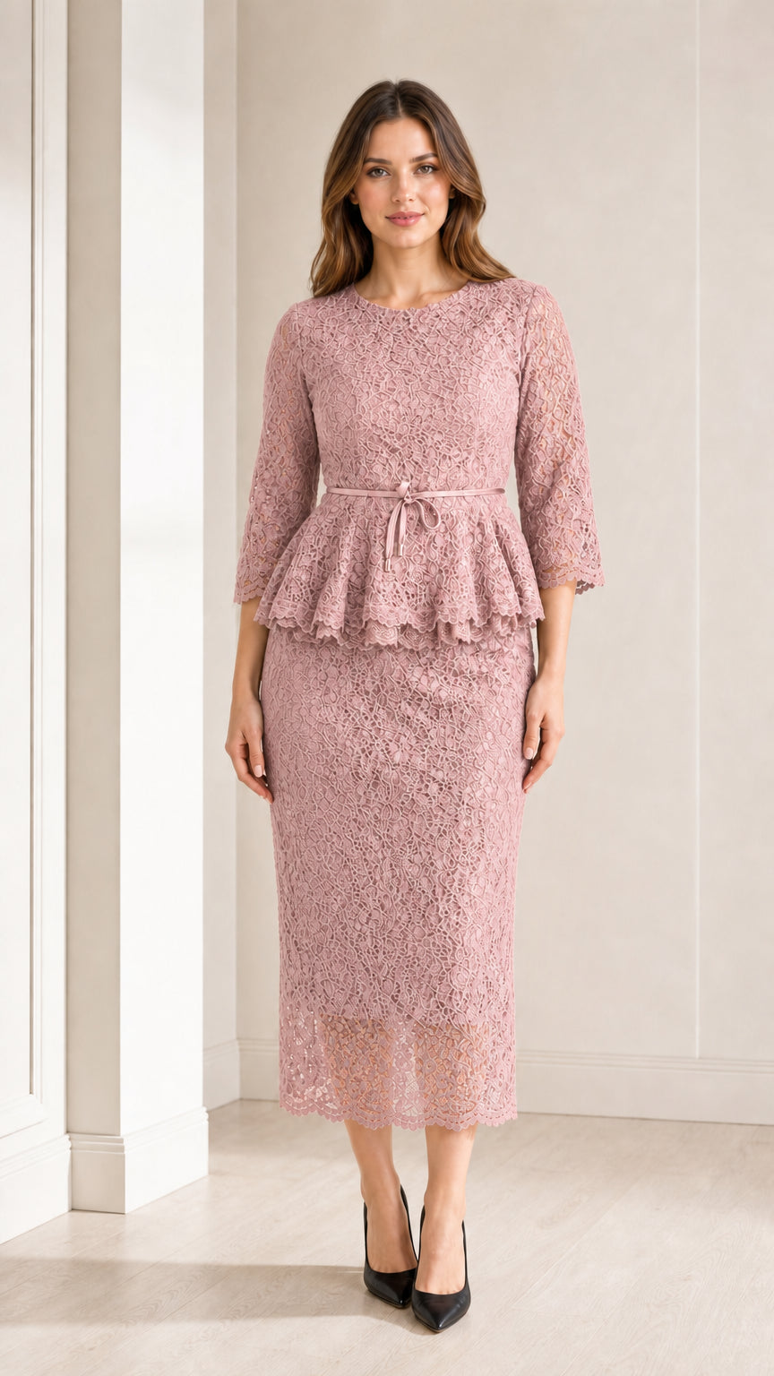 Front view of woman wearing dusty pink lace peplum midi dress