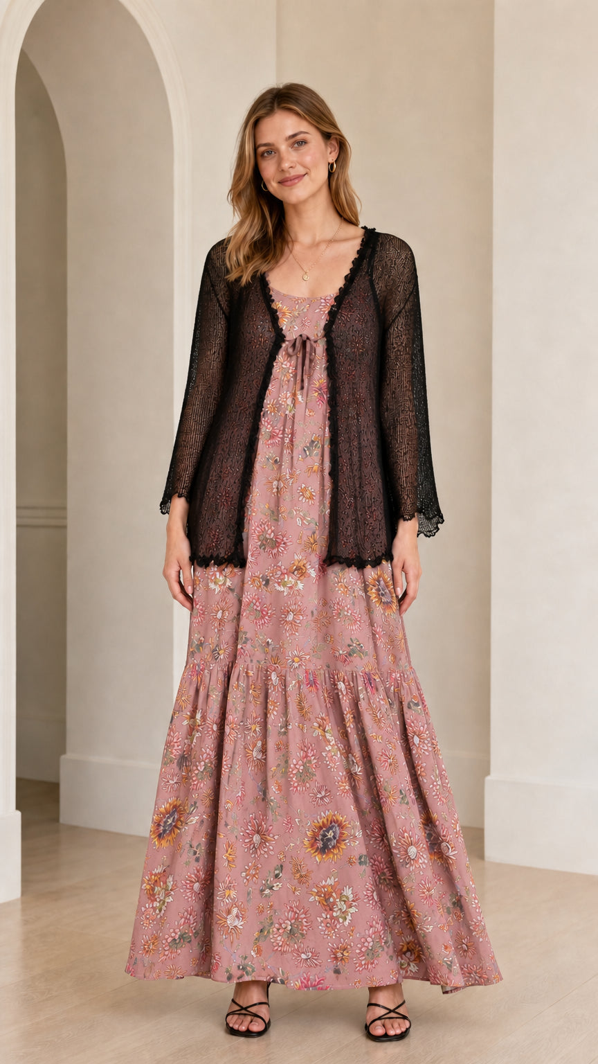 Front view of the blush pink floral maxi dress with sheer black cardigan overlay