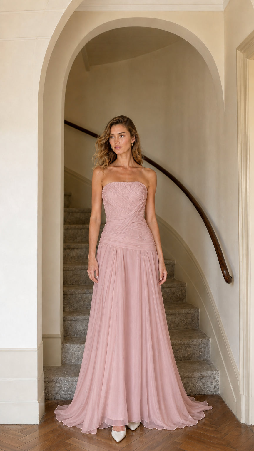 Model wearing dusty rose strapless pleated drop-waist maxi dress