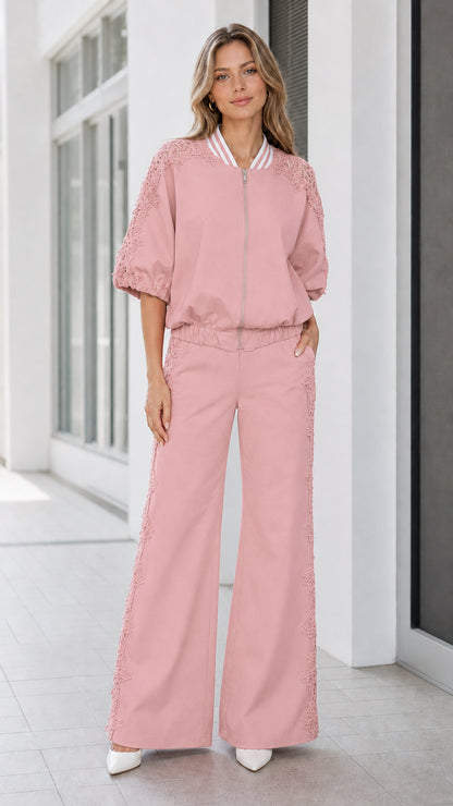 Front view of women's dusty pink lace detail bomber jacket and wide-leg trousers set