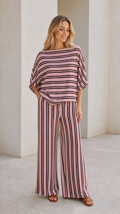Model wearing pink striped top and wide leg pants set