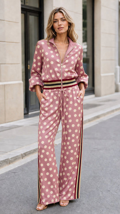 Full front view of woman wearing dusty rose pink polka dot two-piece track set