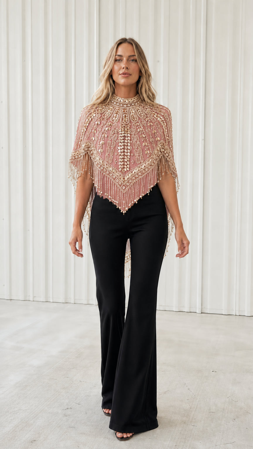 Front view of model wearing blush pink beaded fringe evening capelet