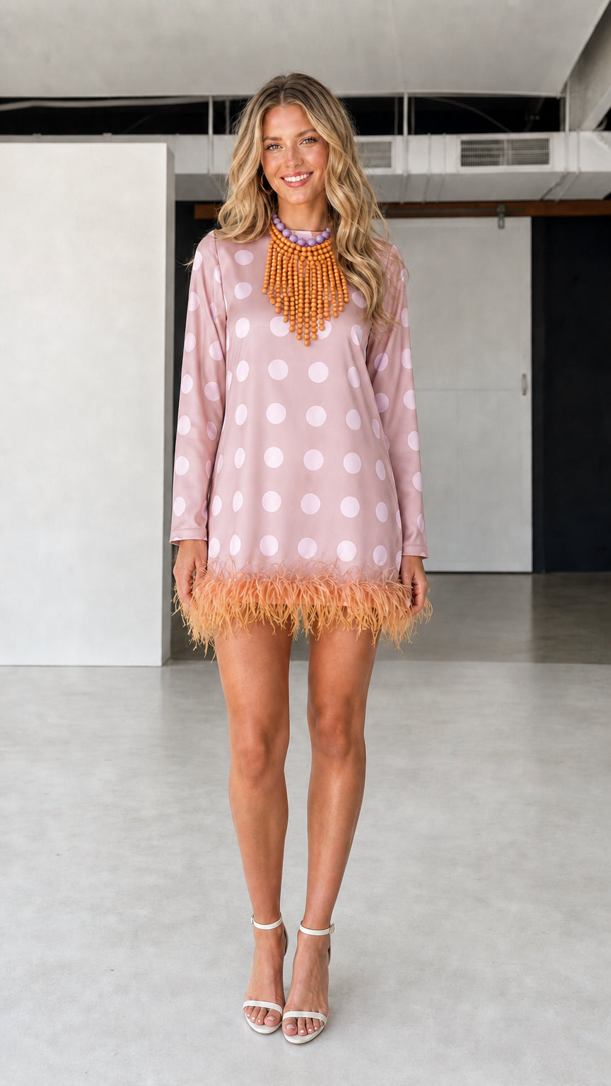 Model wearing pink polka dot feather hem dress